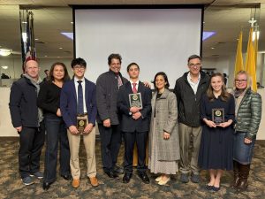 Oratory contest award winners with family members and organisers.